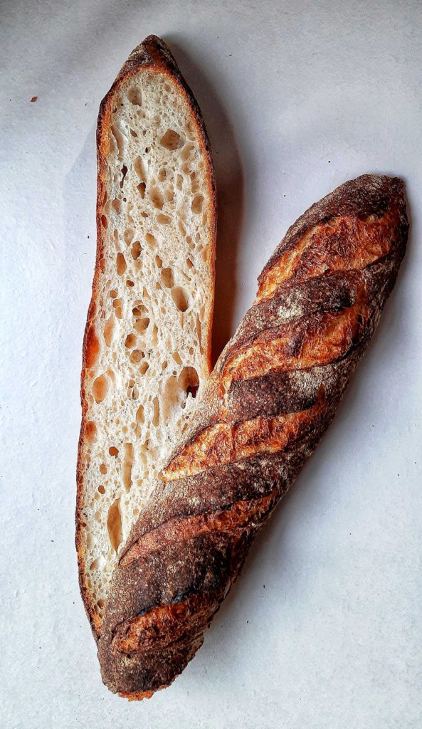  A classic French baguette - crisp, tanned, and thin crust with a netted moist crumb, made with TWF's Series C-8714.